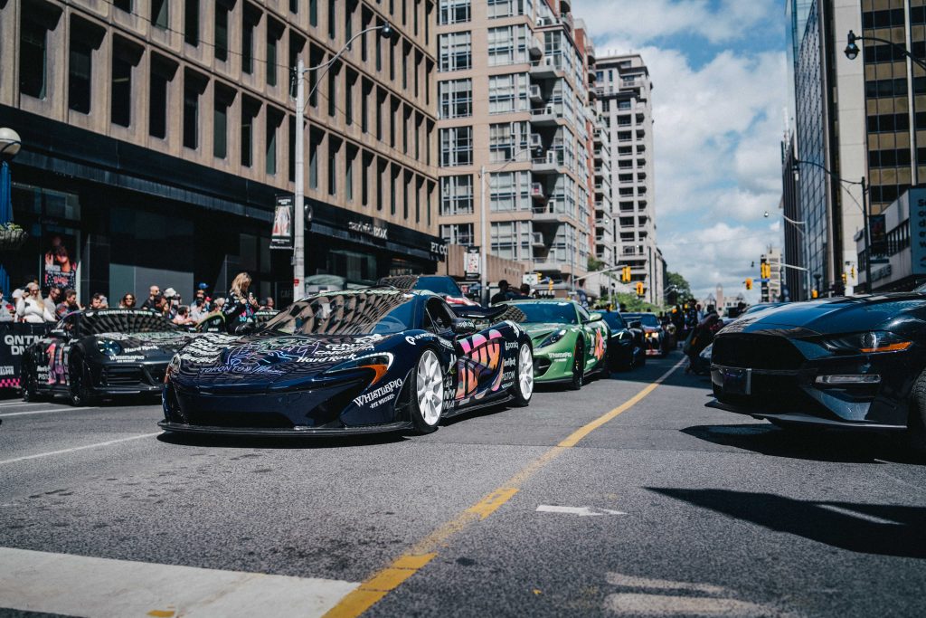 Gumball 3000 cars driving in line in Toronto 2022.